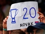A fan holds a placard in support of Serbia's Novak Djokovic during the men's singles final match on day thirteen of the Wimbledon Tennis Championships in London.(AP) A fan holds a placard in support of Serbia's Novak Djokovic during the men's singles final match on day thirteen of the Wimbledon Tennis Championships in London.(AP)