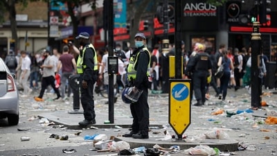 Two police officers stand amidst litter near Leicester Square in London, Sunday, July 11, 2021, prior to the Euro 2020 soccer championship final match between England and Italy which will be played at Wembley Stadium. (AP Photo/Peter Morrison) (AP) Two police officers stand amidst litter near Leicester Square in London, Sunday, July 11, 2021, prior to the Euro 2020 soccer championship final match between England and Italy which will be played at Wembley Stadium. (AP Photo/Peter Morrison) (AP)