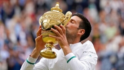 Serbia's Novak Djokovic kisses the winners trophy after he defeated Italy's Matteo Berrettini in the men's singles final on day thirteen of the Wimbledon Championships in London. (AP)