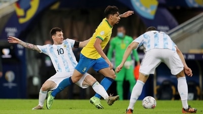Brazil's Lucas Paqueta in action with Argentina's Lionel Messi (REUTERS)