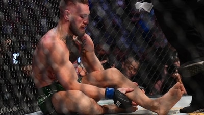 Conor McGregor holds his leg after suffering an injury against Dustin Poirier during UFC 264 at T-Mobile Arena (USA TODAY Sports)