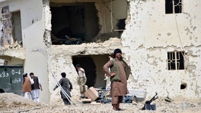 Afghan men inspect the site of a car bomb attack in Kandahar province, Afghanistan. (REUTERS FILE PHOTO)