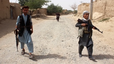 Armed Afghan militias patrol on the outskirts of Takhar province, Afghanistan. (REUTERS)