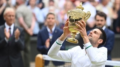 Serbia's Novak Djokovic celebrates with the trophy after winning his final match against Italy's Matteo Berrettini. (REUTERS)