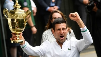 Wimbledon - Serbia's Novak Djokovic celebrates with the trophy after winning his final match against Italy's Matteo Berrettini. (REUTERS)