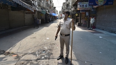 A Delhi police personnel stands guard as the Gaffar Market closed for 48 hours for flouting Covid norms in New Delhi on July 10, 2021. (PTI Photo) A Delhi police personnel stands guard as the Gaffar Market closed for 48 hours for flouting Covid norms in New Delhi on July 10, 2021. (PTI Photo)
