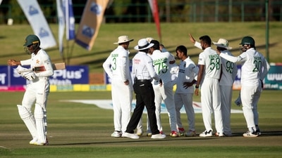 Zimbabwe batsman Milton Shumba,left, walks off the pitch after been dismissed on the second day of the test cricket match between Zimbabwe and Bangladesh at Harare Sports Club in Harare,Thursday, July,8, 2021.(AP Photo/Tsvangirayi Mukwazhi) (AP)