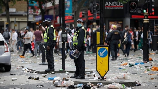 Two police officers stand amidst litter near Leicester Square in London, Sunday, July 11, 2021, prior to the Euro 2020 soccer championship final match between England and Italy which will be played at Wembley Stadium. (AP Photo/Peter Morrison)(AP)