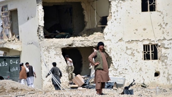 Afghan men inspect the site of a car bomb attack in Kandahar province, Afghanistan.(REUTERS FILE PHOTO)