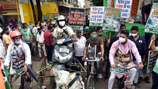 Trinamul Congress supporters pull a scooty on a tri-cart and others ride bicycles during a demonstrative protest against fuel price hikes at a petrol pump, in Kolkata on Saturday. (ANI Photo)