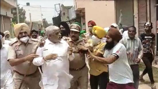 Farmers manhandling councillor Shanti Swarup in Rajpura on Sunday. (Video grab)