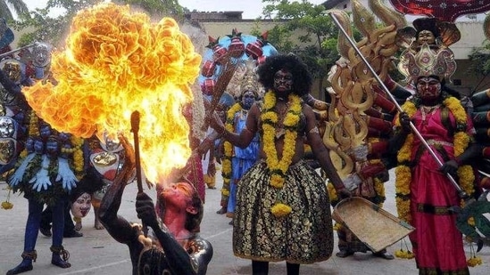 Bonalu celebrations in Hyderabad: A performer blows fire from his mouth as he performs during the annual Hindu religious festival. (Reuters / Krishnendu Halder)