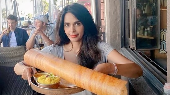 Mallika Sherawat poses with her meal at an eatery in Los Angeles.