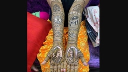 The image shows the bride sporting Manchester United and Mumbai Indians logos mehendi design.