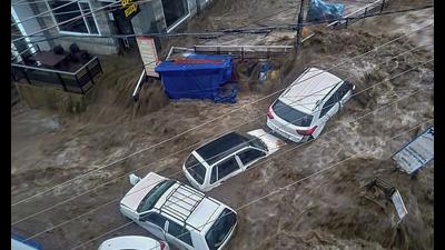 Vehicles trapped in flood water due to heavy rain after a cloudburst, at Mcleodganj near Dharamshala, Monday. (PTI) Vehicles trapped in flood water due to heavy rain after a cloudburst, at Mcleodganj near Dharamshala, Monday. (PTI)