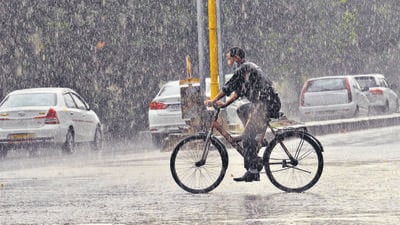A cyclist caught in the monsoon showers that lashed Chandigarh on Monday evening. (Keshav Singh/HT)