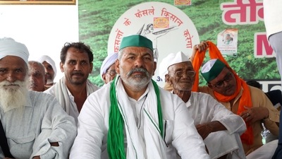 Bhartiya Kisan Union (BKU) leader Rakesh Tikait along with farmers from Haryana during a protest against three farm laws at Ghazipur border, near New Delhi on Sunday. (ANI Photo)