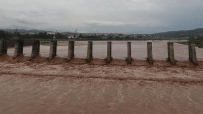 A view of flooded Tawi river after heavy rain in Jammu on Monday. (PTI)