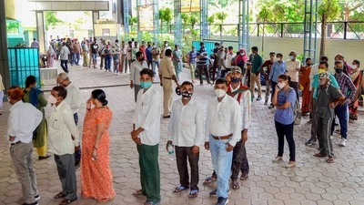 People stand in a queue to receive a dose of Covid-19 vaccine in Bhopal, on Monday. (PTI Photo) People stand in a queue to receive a dose of Covid-19 vaccine in Bhopal, on Monday. (PTI Photo)