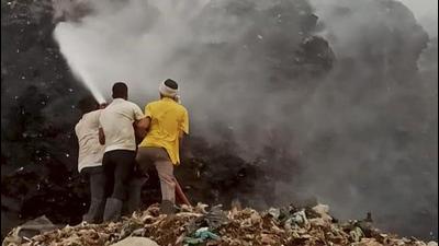 Firefighters are engaged in operations to douse the flames at the landfill. (PTI) Firefighters are engaged in operations to douse the flames at the landfill. (PTI)
