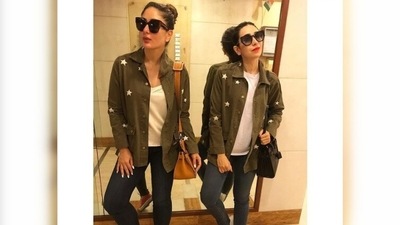 Karisma and Kareena twin in white t-shirts, denims and army green jacket. While Kareena teamed her look with red converse shoes, Karisma opted for white sneakers. (Instagram/@therealkarismakapoor) Karisma and Kareena twin in white t-shirts, denims and army green jacket. While Kareena teamed her look with red converse shoes, Karisma opted for white sneakers. (Instagram/@therealkarismakapoor)