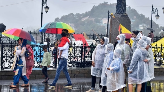 Shimla, India July 12: Tourists in raincoats and others walking with umbrellas during the rain at Ridge, Shimla, Himachal Pradesh, India on Monday, July 12, 2021.(Photo by Deepak Sansta / Hindustan Times)