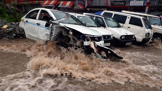 Several vehicles were damaged in a flash flood near Dharamshala, in Kangra district, Himachal Pradesh.(HT Photo)