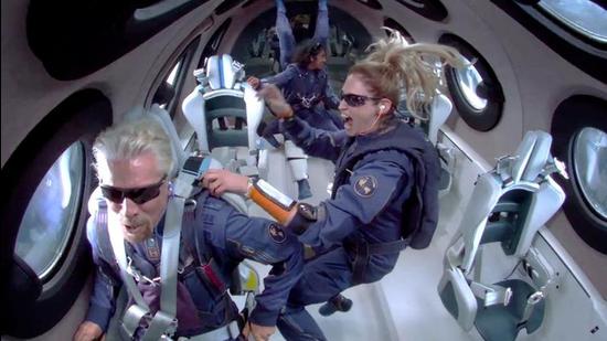 Billionaire Richard Branson makes a statement as crew members Beth Moses and Sirisha Bandla float in zero gravity on board Virgin Galactic's passenger rocket plane VSS Unity after reaching the edge of space above Spaceport America near Truth or Consequences, New Mexico, US July 11, 2021. (via REUTERS) Billionaire Richard Branson makes a statement as crew members Beth Moses and Sirisha Bandla float in zero gravity on board Virgin Galactic's passenger rocket plane VSS Unity after reaching the edge of space above Spaceport America near Truth or Consequences, New Mexico, US July 11, 2021. (via REUTERS)
