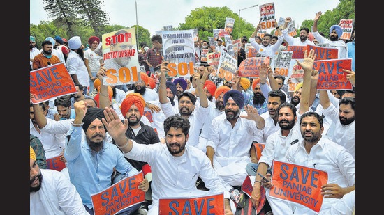 Members of the Youth Akali Dal and Students Organisation of India protesting outside the vice-chancellor’s office on the Panjab University campus in Chandigarh on Monday.