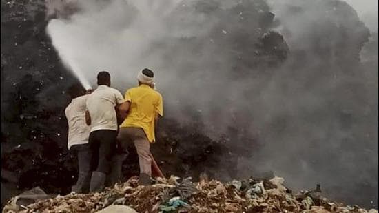 Firefighters are engaged in operations to douse the flames at the landfill. (PTI) Firefighters are engaged in operations to douse the flames at the landfill. (PTI)