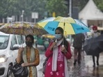 People with umbrellas during light rain at Connaught Place in New Delhi, India. (Photo by Sanchit Khanna/ Hindustan Times) People with umbrellas during light rain at Connaught Place in New Delhi, India. (Photo by Sanchit Khanna/ Hindustan Times)