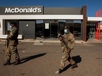 Soldiers patrol at a shopping centre in Soweto, Johannesburg, Tuesday July 13, 2021. (AP) Soldiers patrol at a shopping centre in Soweto, Johannesburg, Tuesday July 13, 2021. (AP)