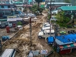 Flood water surges through a street in Dharamshala after heavy rain on Monday.(PTI Photo) Flood water surges through a street in Dharamshala after heavy rain on Monday.(PTI Photo)