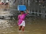 A woman wades through a water-logged subway during Chennai rains.