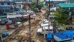Flood water surges through a street in Dharamshala after heavy rain on Monday.(PTI Photo) Flood water surges through a street in Dharamshala after heavy rain on Monday.(PTI Photo)