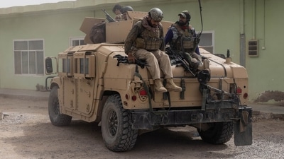 Members of Afghan Special Forces climb down from a humvee as they arrive at their base after heavy clashes with Taliban during the rescue mission of a police officer besieged at a check post in Kandahar province in Afghanistan. (Reuters)