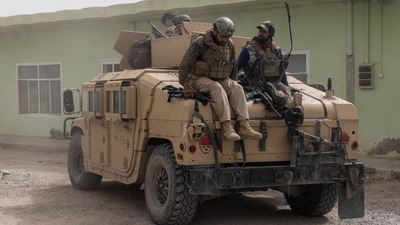 Members of Afghan Special Forces climb down from a humvee as they arrive at their base after heavy clashes with Taliban during the rescue mission of a police officer besieged at a check post, in Kandahar province, Afghanistan. (REUTERS)