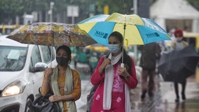 People with umbrellas during light rain at Connaught Place in New Delhi, India. (Photo by Sanchit Khanna/ Hindustan Times) People with umbrellas during light rain at Connaught Place in New Delhi, India. (Photo by Sanchit Khanna/ Hindustan Times)