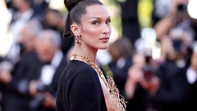 Bella rounded off her Cannes look with strappy embellished pumps, rhinestone adorned earrings and a matching ring. She tied her tresses in a sleek top bun with a section of her locks left open in the back. (Instagram) Bella rounded off her Cannes look with strappy embellished pumps, rhinestone adorned earrings and a matching ring. She tied her tresses in a sleek top bun with a section of her locks left open in the back. (Instagram)