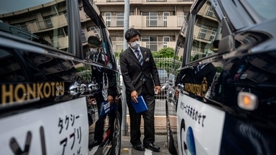 Yuki Kawaguchi conducting a safety check for the vehicles at the Shinagawa office of his employer Nihon Kotsu in Tokyo on July 7. The fan ban is "inevitable,: Kawaguchi told AFP, describing it as "the strongest step (organisers) can take short of cancellation." Japan has seen nearly 15,000 Covid-19 deaths, and around 17 percent of the population is fully vaccinated. (Philip Fong / AFP) Yuki Kawaguchi conducting a safety check for the vehicles at the Shinagawa office of his employer Nihon Kotsu in Tokyo on July 7. The fan ban is "inevitable,: Kawaguchi told AFP, describing it as "the strongest step (organisers) can take short of cancellation." Japan has seen nearly 15,000 Covid-19 deaths, and around 17 percent of the population is fully vaccinated. (Philip Fong / AFP)