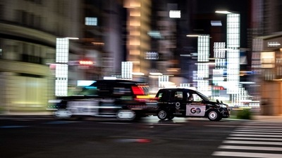 Taxis travelling through the Ginza district in Tokyo on July 7. Kawaguchi said he wants to get a jab quickly, despite his concerns over side effects. "I don't deny that I want to get vaccinated as soon as possible, as we drive many people we don't know. But at the same time I hear reports of side effects, so I have mixed feelings." (Philip Fong / AFP) Taxis travelling through the Ginza district in Tokyo on July 7. Kawaguchi said he wants to get a jab quickly, despite his concerns over side effects. "I don't deny that I want to get vaccinated as soon as possible, as we drive many people we don't know. But at the same time I hear reports of side effects, so I have mixed feelings." (Philip Fong / AFP)