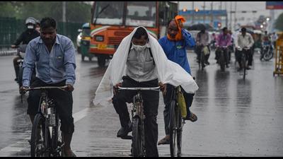 Commuters during rain as monsoon reaches New Delhi on Tuesday, July 13. (PTI) Commuters during rain as monsoon reaches New Delhi on Tuesday, July 13. (PTI)