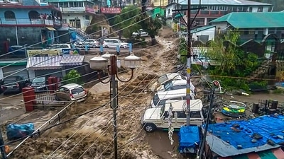 Flood water surges through a street in Dharamshala after heavy rain on Monday. (PTI Photo) Flood water surges through a street in Dharamshala after heavy rain on Monday. (PTI Photo)
