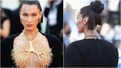 For her second appearance on the red carpet, Bella wore a risqué deep-cut neckline Schiaparelli dress with a gilded gold necklace to cover her breasts. The gown is from the Haute Couture Fall-Winter 2021/22 collection and designed by the Artistic Director of Schiaparelli, Daniel Roseberry. (Instagram/@insta_world_of_fashion) For her second appearance on the red carpet, Bella wore a risqué deep-cut neckline Schiaparelli dress with a gilded gold necklace to cover her breasts. The gown is from the Haute Couture Fall-Winter 2021/22 collection and designed by the Artistic Director of Schiaparelli, Daniel Roseberry. (Instagram/@insta_world_of_fashion)