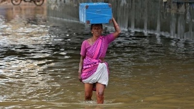 A woman wades through a water-logged subway during Chennai rains. (REUTERS)