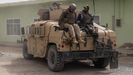 Members of Afghan Special Forces climb down from a humvee as they arrive at their base after heavy clashes with Taliban during the rescue mission of a police officer besieged at a check post in Kandahar province in Afghanistan.(Reuters)