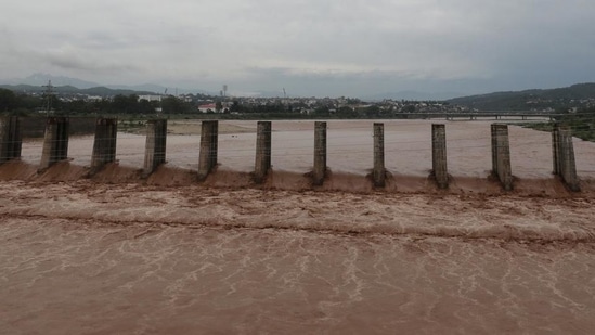 A view of the flooded Tawi river after heavy rain in Jammu on Monday. (PTI)