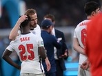 England's Harry Kane, center, consoles Bukayo Saka after the penalty shootout of the Euro 2020 soccer final match between England and Italy at Wembley stadium in London, Sunday, July 11, 2021.