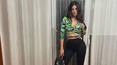 Natasa did a little ramp walk of sorts in the video she posted to her feed in which she wore an abstract printed green crop top that hugged her tiny frame and high waisted pants that had tie-up detail at the waist and flared bottoms. (Instagram) Natasa did a little ramp walk of sorts in the video she posted to her feed in which she wore an abstract printed green crop top that hugged her tiny frame and high waisted pants that had tie-up detail at the waist and flared bottoms. (Instagram)