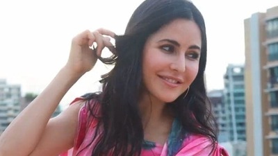 Katrina wore silver hoops in her ears, sporting minimal nude make-up, her shoulder length dark hair flowed in beachy waves around her in the video as she posed playfully. (Instagram) Katrina wore silver hoops in her ears, sporting minimal nude make-up, her shoulder length dark hair flowed in beachy waves around her in the video as she posed playfully. (Instagram)